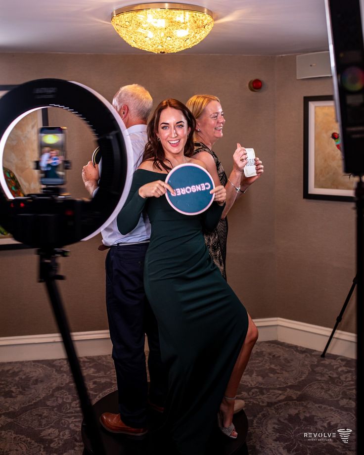 Guests holding a sign on the 360 photo booth platform