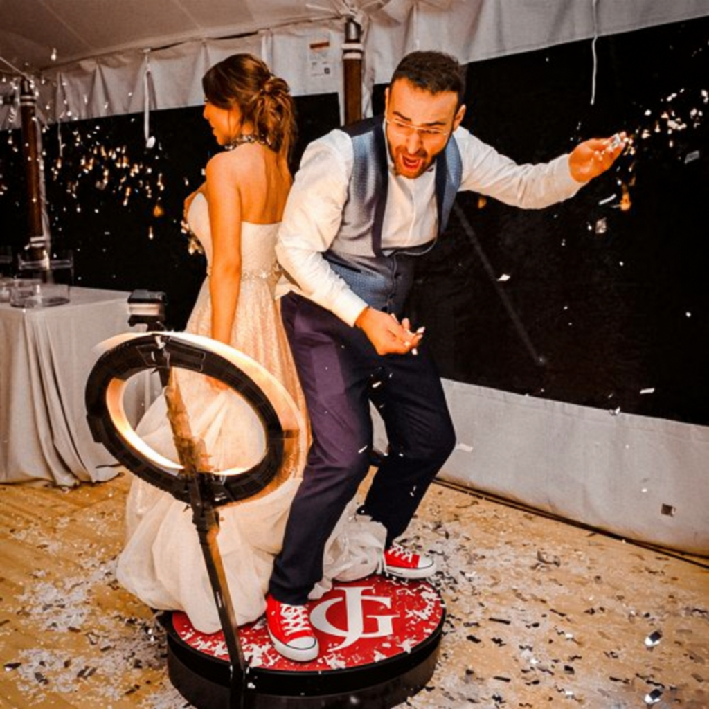Bride and groom dancing on the 360 photo booth platform at a Toronto wedding
