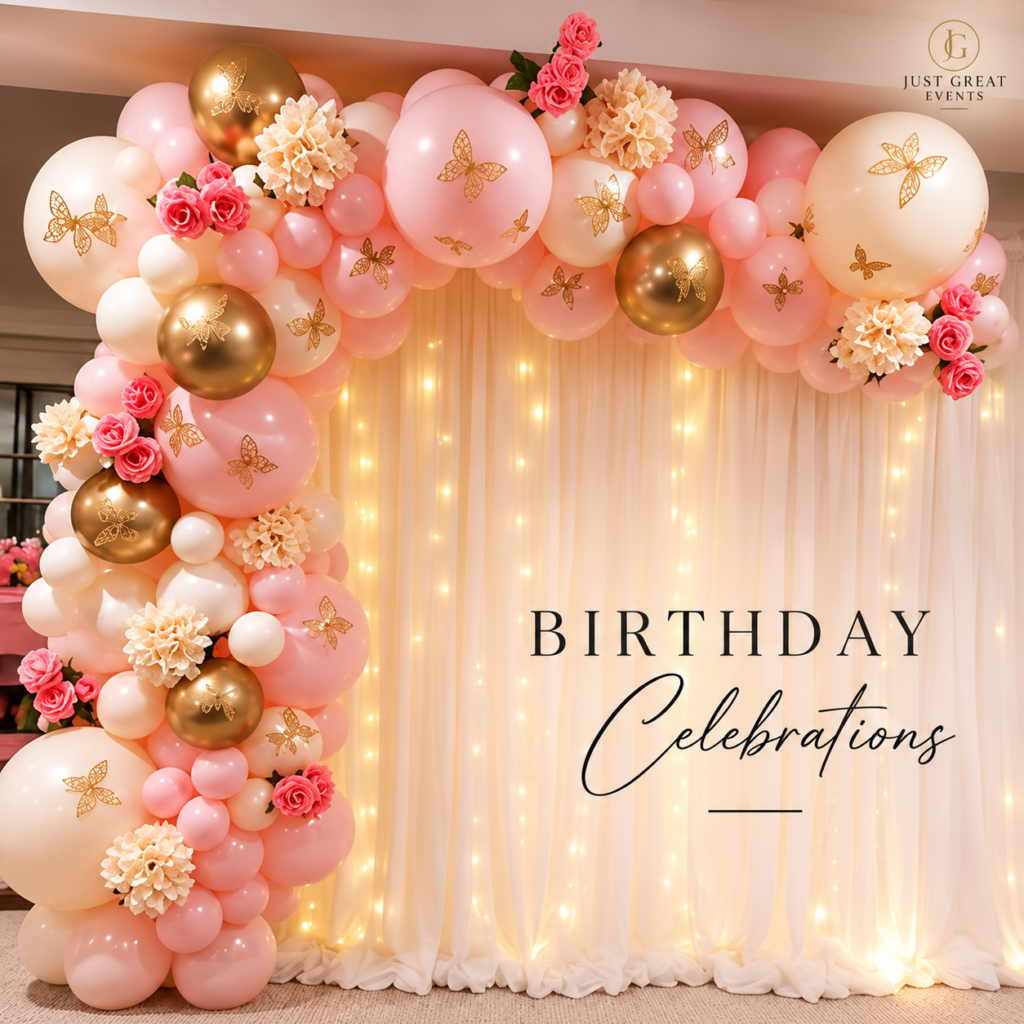 Birthday balloon arch with gold and pink balloons and a fairy light backdrop