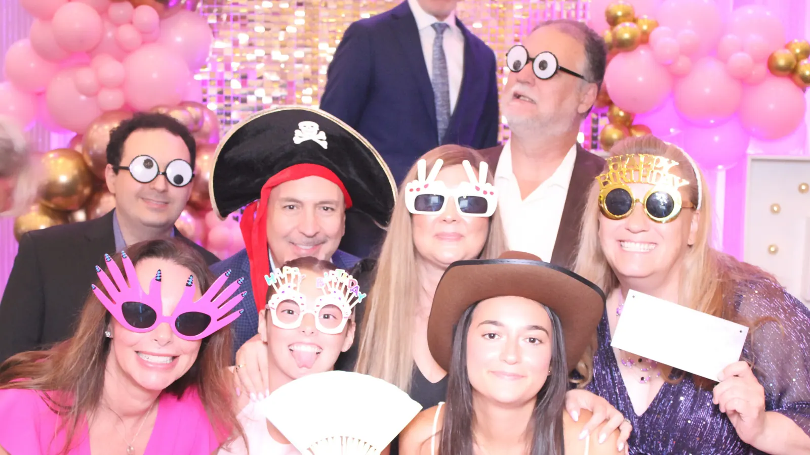 Party guests with hats and glasses at a Just Great Events photo booth in Toronto
