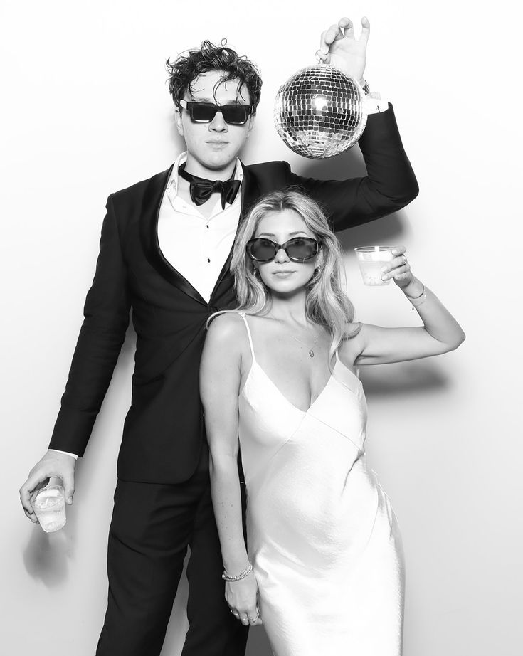 Couple with a disco ball in a black and white Glam Booth portrait in Toronto