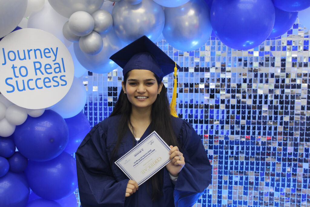College graduate holding a diploma at a Toronto graduation photo booth