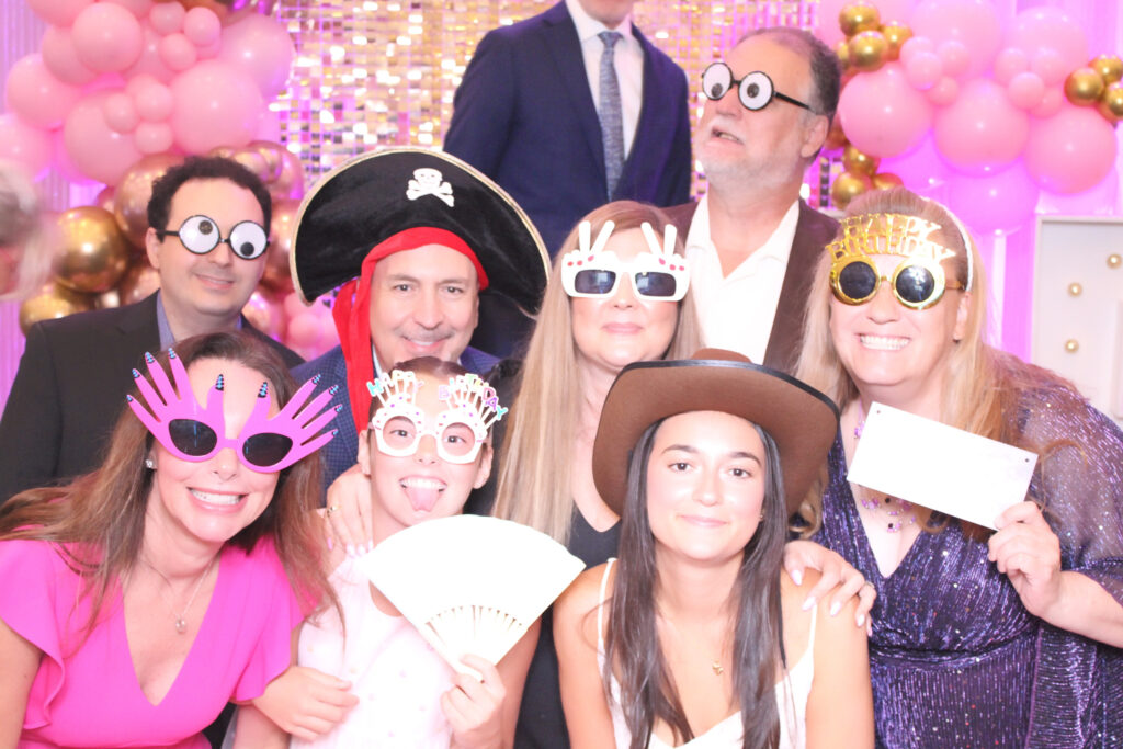 Party guests with hats and glasses at a Just Great Events photo booth