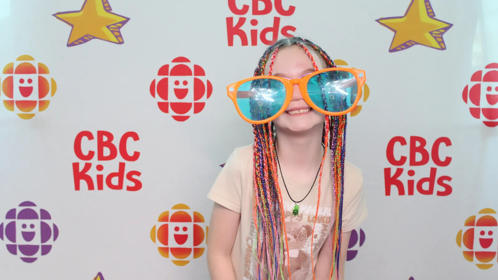 Child with oversized glasses at a branded photo booth in Brampton