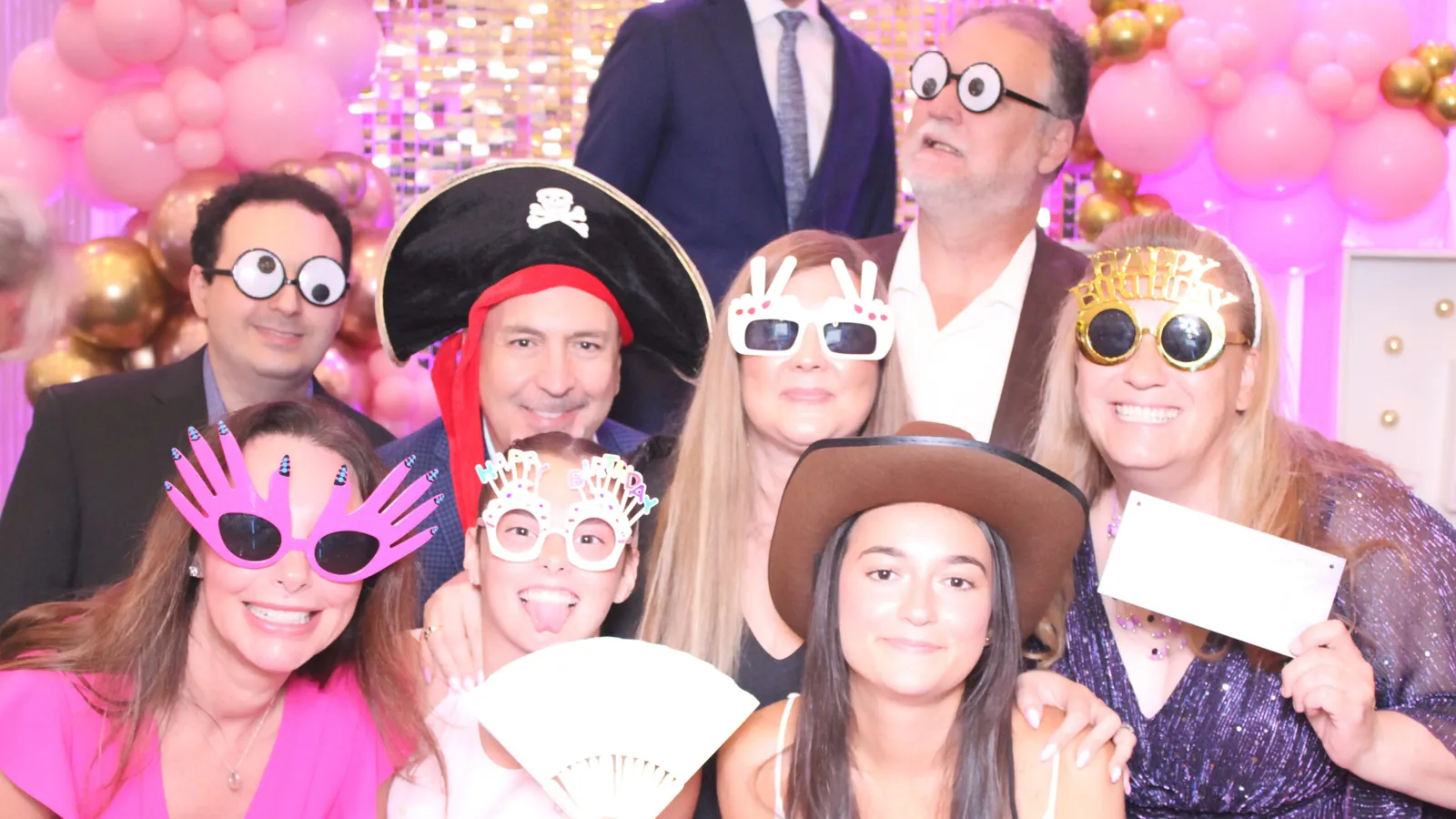 Party guests with props at a photo booth in Mississauga