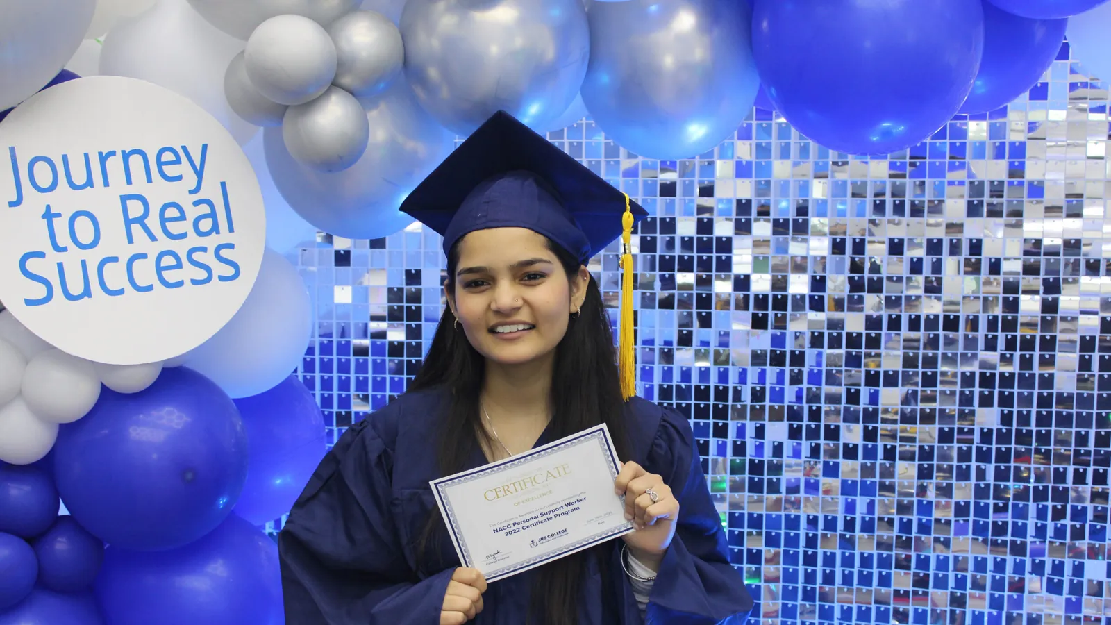 Graduate with a balloon backdrop at a photo booth in North York